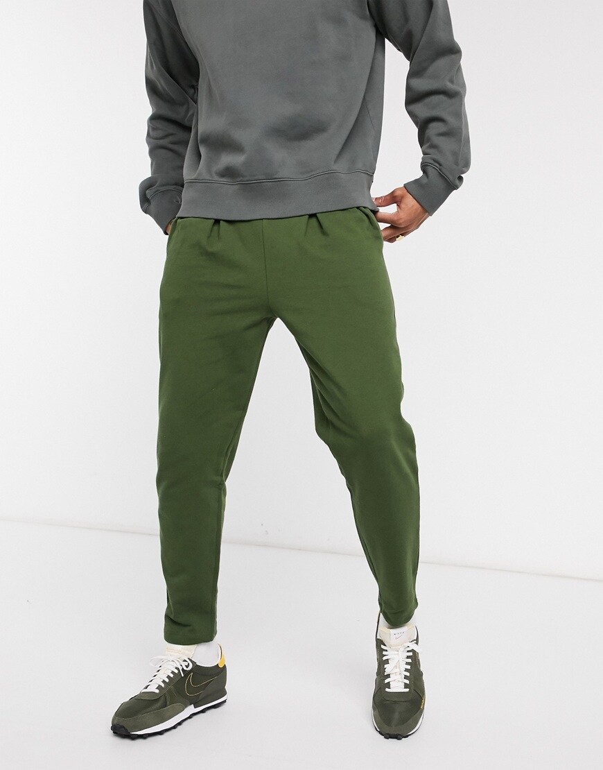 A picture of a model wearing green joggers.  Available at ASOS |ASOS Style Feed