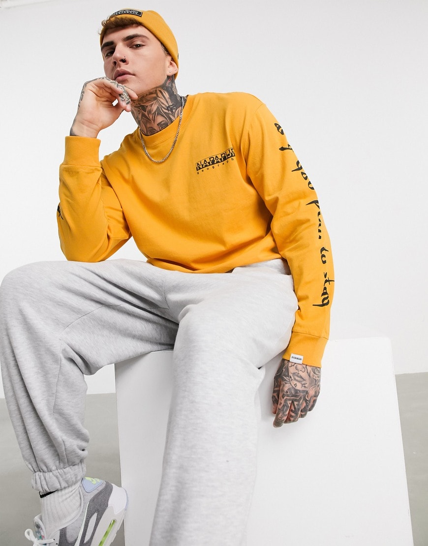 A picture of a model wearing a yellow long sleeve t-shirt.  Available at ASOS |ASOS Style Feed