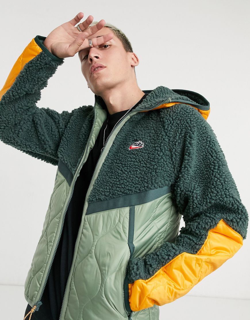 An image of a man wearing a khaki jacket by Nike | ASOS Style Feed