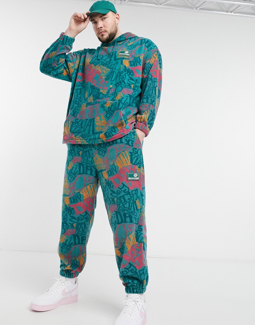 An image of a man wearing a printed turquoise tracksuit by ASOS Design | ASOS Style Feed