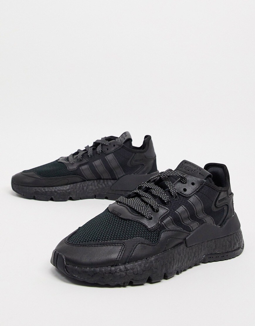 Model wearing adidas Originals Nite Jogger trainers in triple black