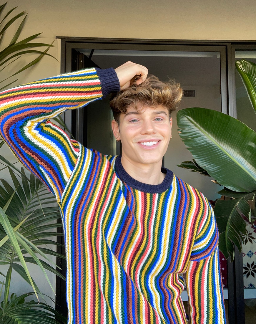 Nicky Champa smiling in a striped jumper | ASOS Style Feed