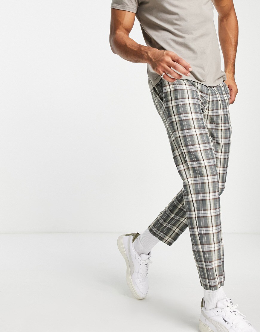 An image of a model wearing checked grey and white trousers with a white trainer. | ASOS Style Feed