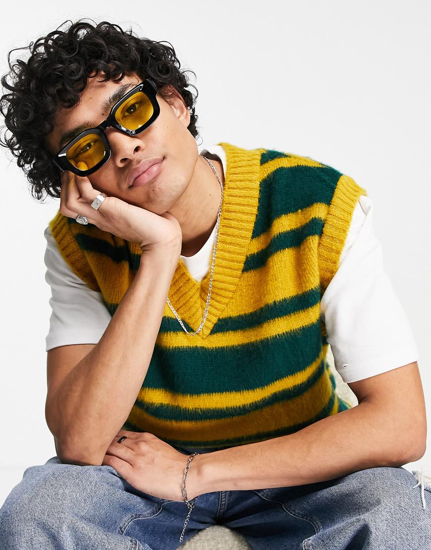 Man in a striped sweater vest.