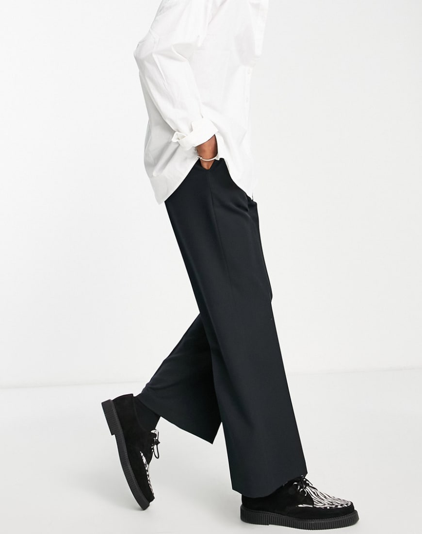A pair of flared black trousers.