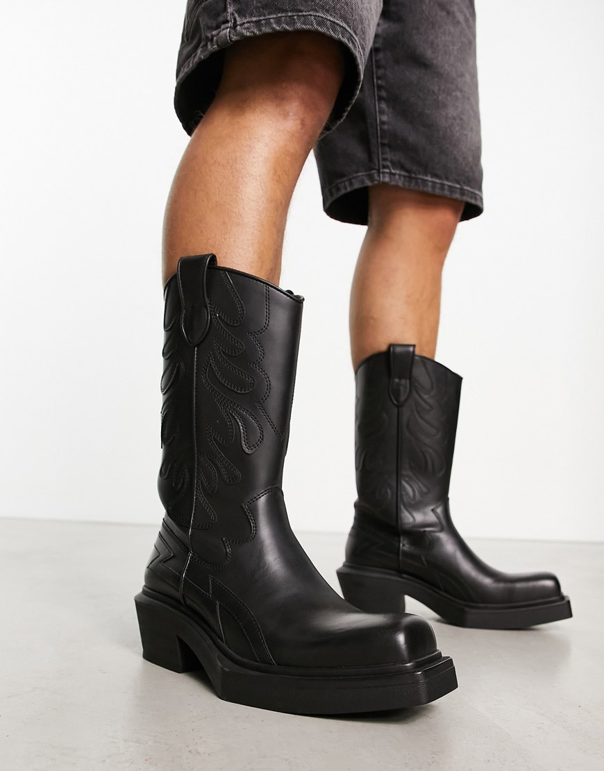 Bershka heeled PU leather cowboy boot in black.