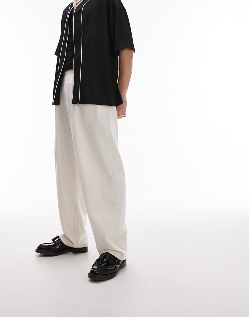 model wearing white joggers