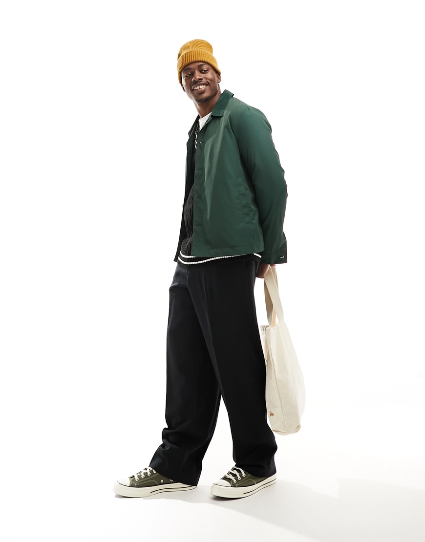 model wearing a green jacket