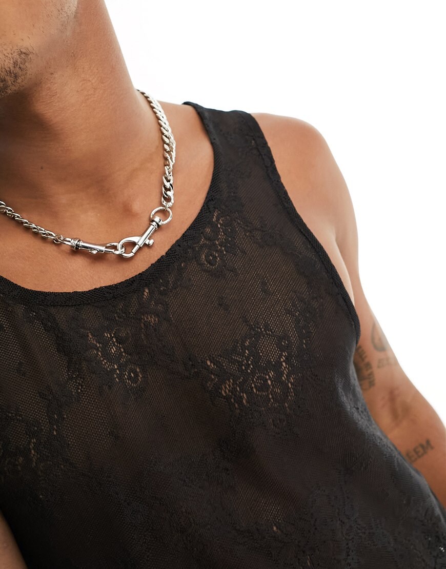 A model wearing a sheer black vest 