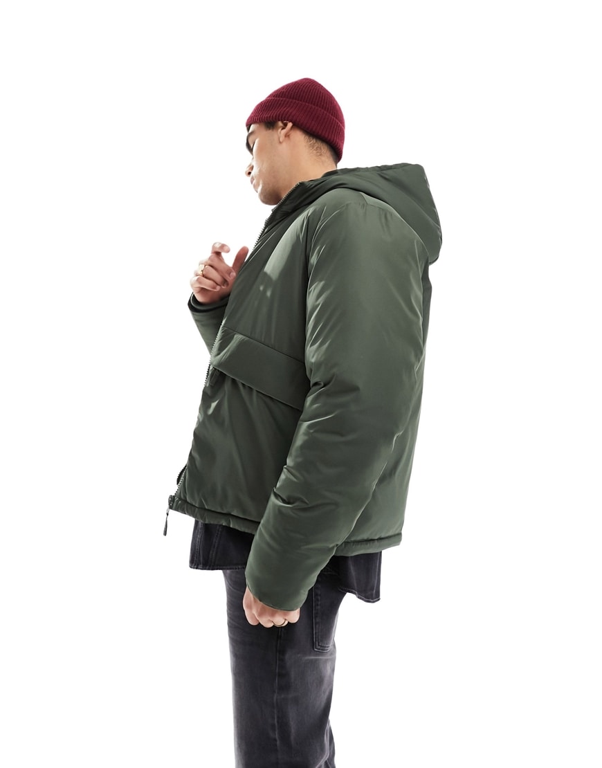 Model wearing a khaki hooded puffer jacket