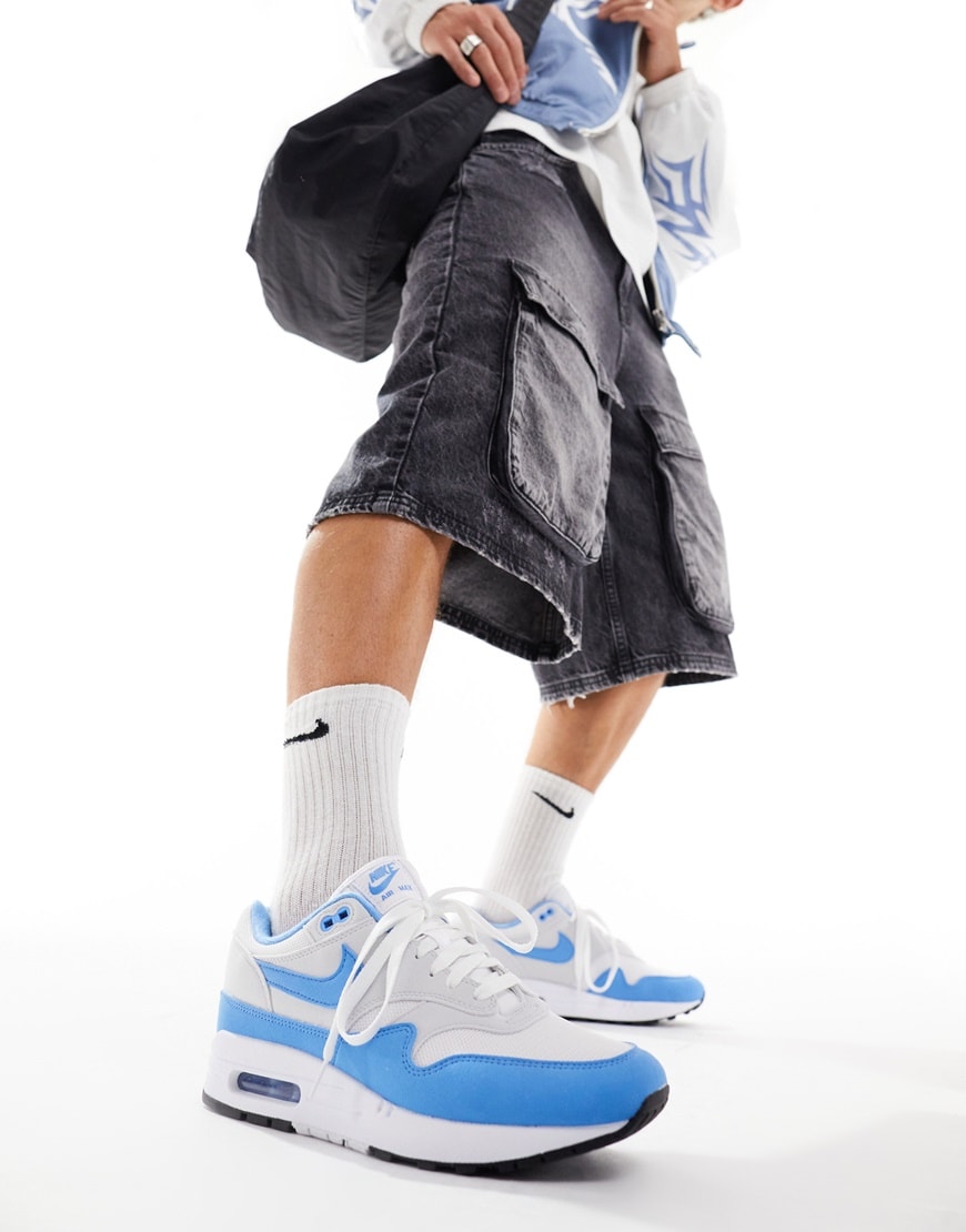 model wearing blue and white nike air max 1s