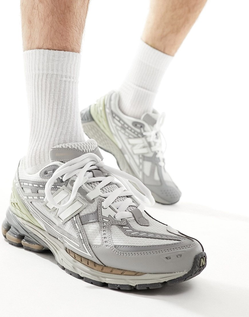 model wearing grey new balance trainers