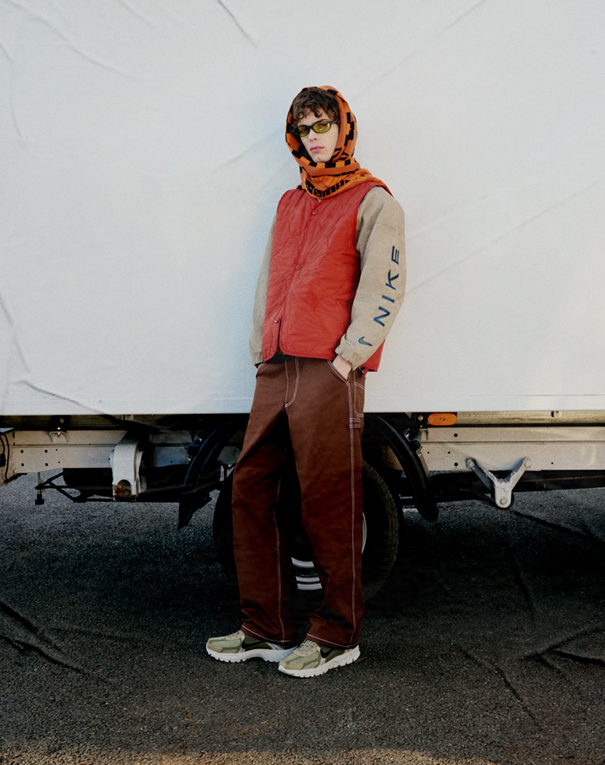 Jack wears the Nike Life quilted gilet in orange and Nike Life carpenter trousers in brown | ASOS Style Feed