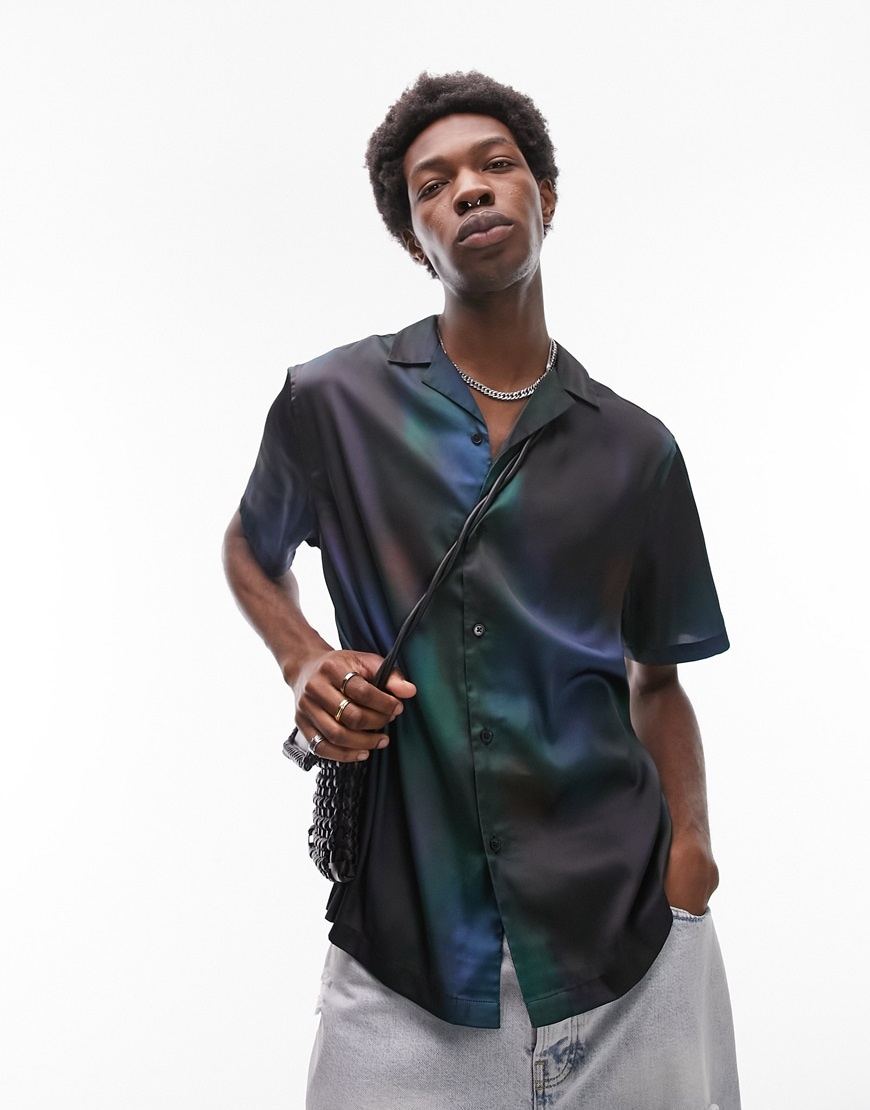 Man wearing black satin Topman short-sleeve shirt with galaxy print