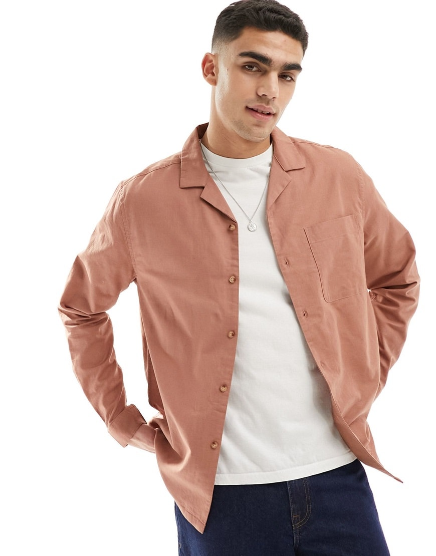 Man wearing rust-coloured long-sleeve ASOS Design button-down shirt