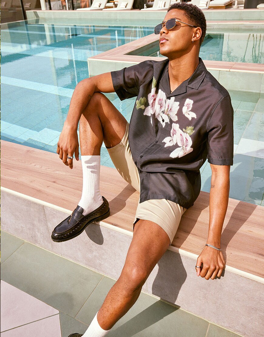 Model wearing floral print shirt with shorts and loafers | ASOS Style Feed
