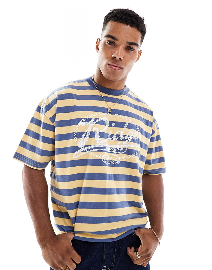 A model wearing a blue and yellow striped boxy T-shirt