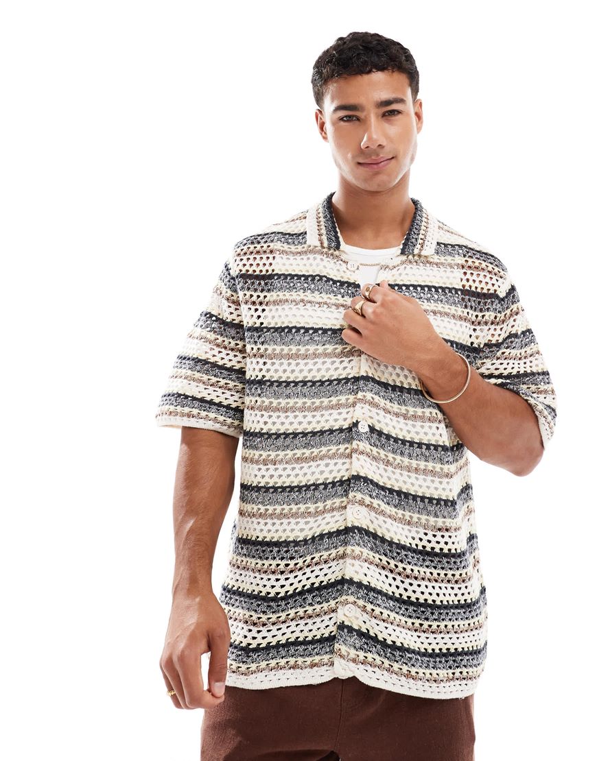 A model in a striped crochet shirt