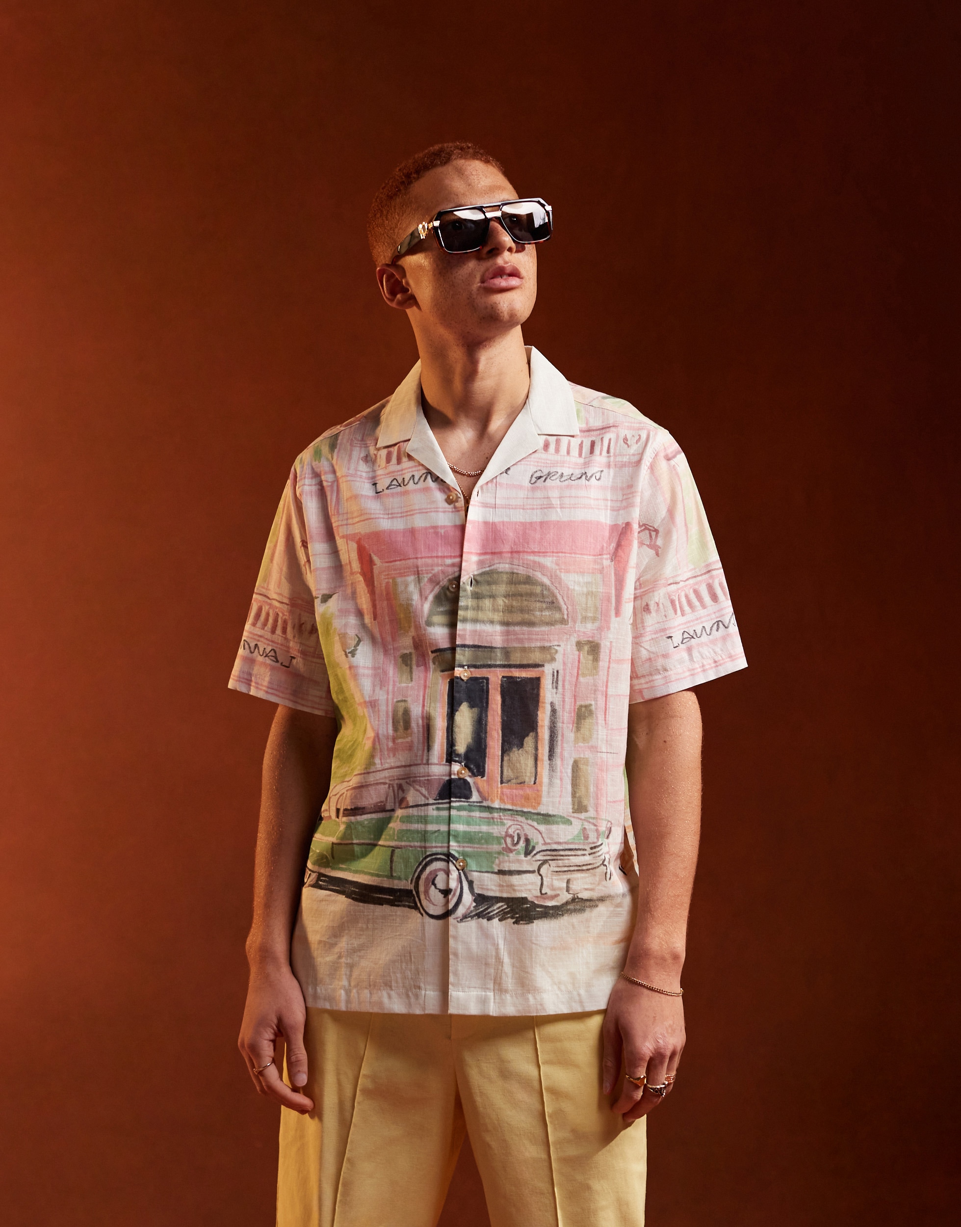 Person wearing a button down shirt with a car graphic