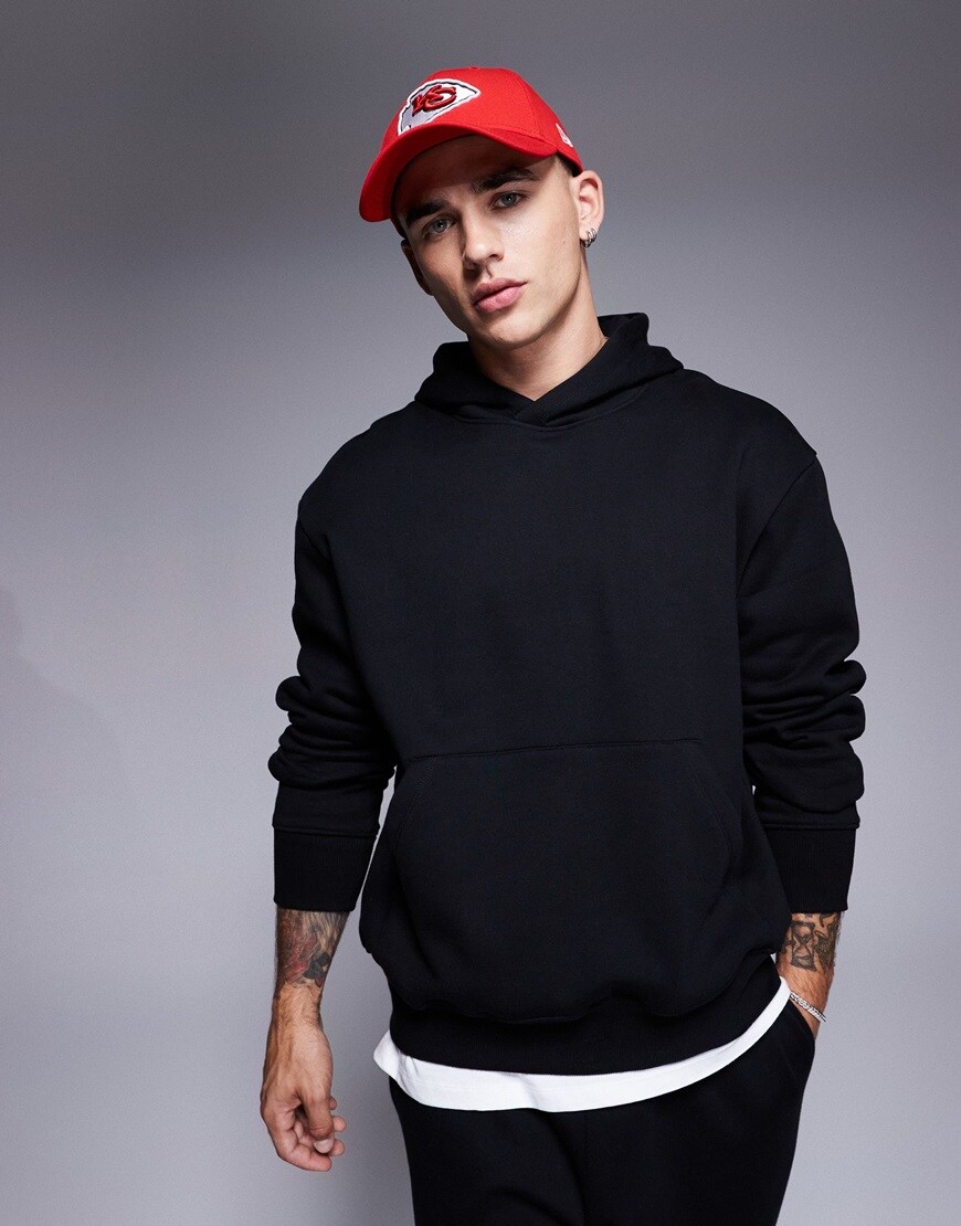 Man wearing black thick hoodie and red cap