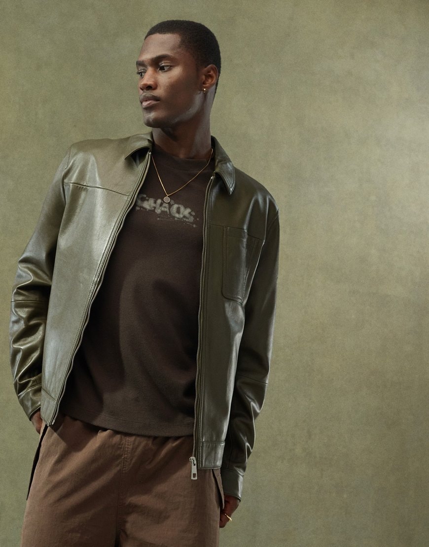 Model wearing green leather Harrington jacket with t shirt