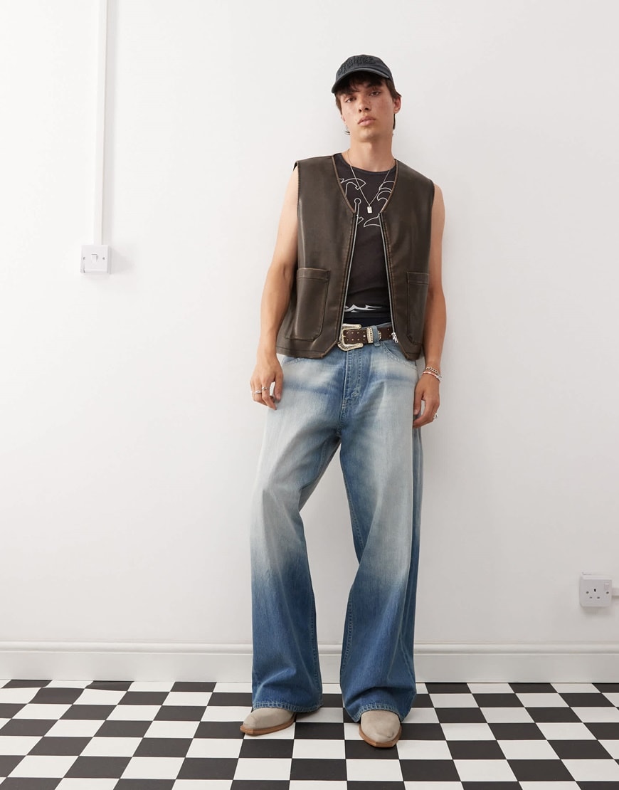 Cheap Monday baggy blue jeans on model wearing vest top