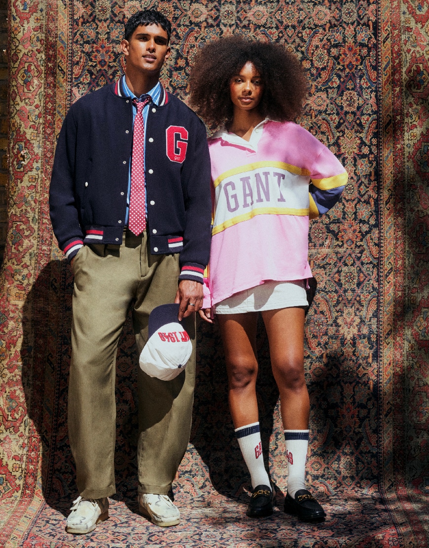 Model wearing navy jumper and model wearing rugby shirt and a white skirt