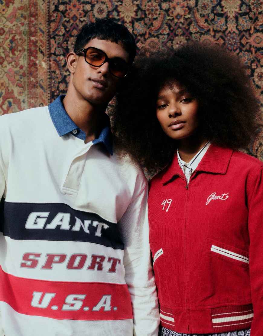 Model wearing white rugby shirt and model wearing red jacket