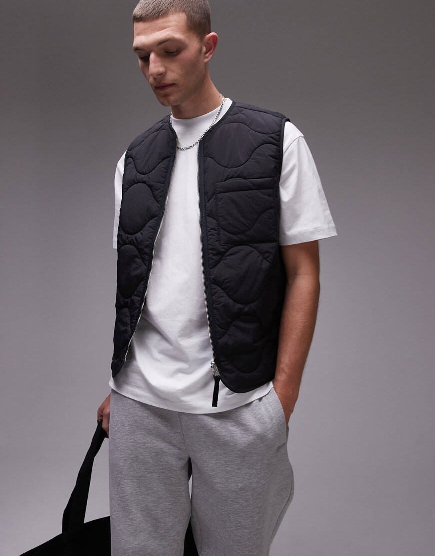 Quilted gilet in black over a white T-shirt