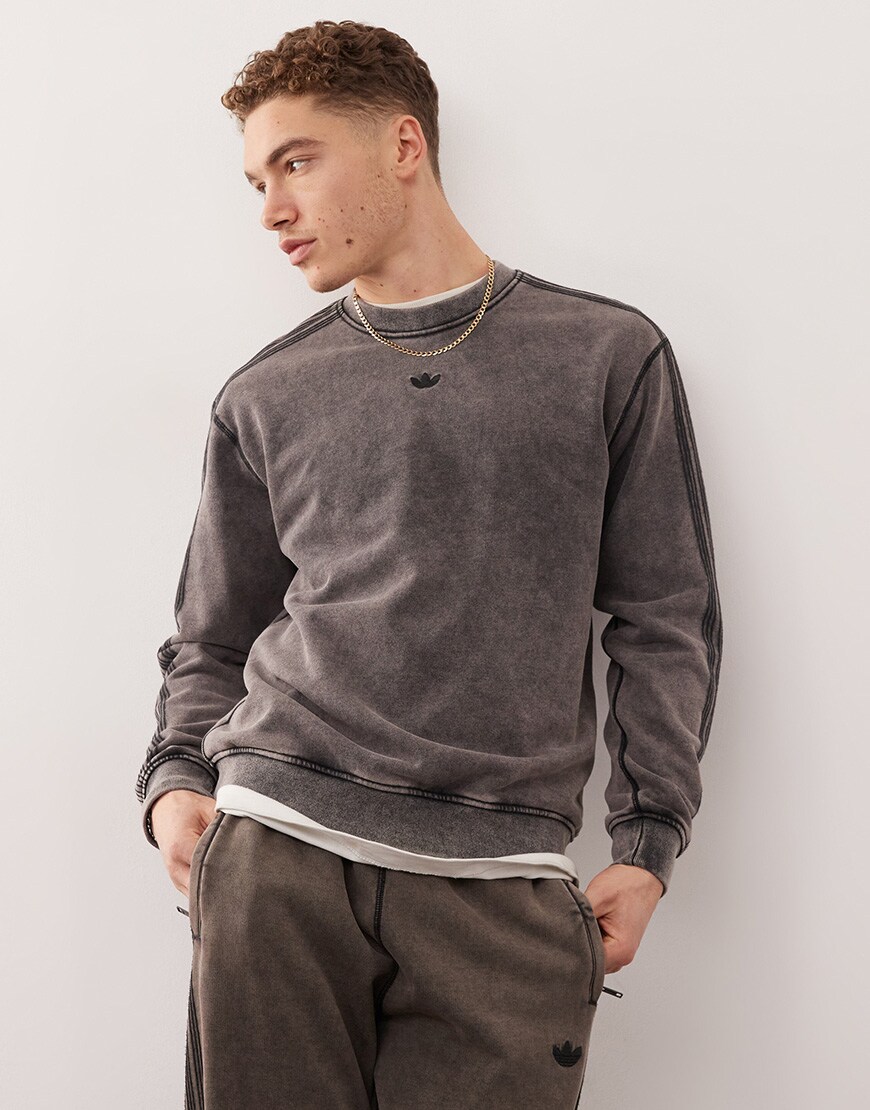 A model wearing a grey adidas Originals sweatshirt
