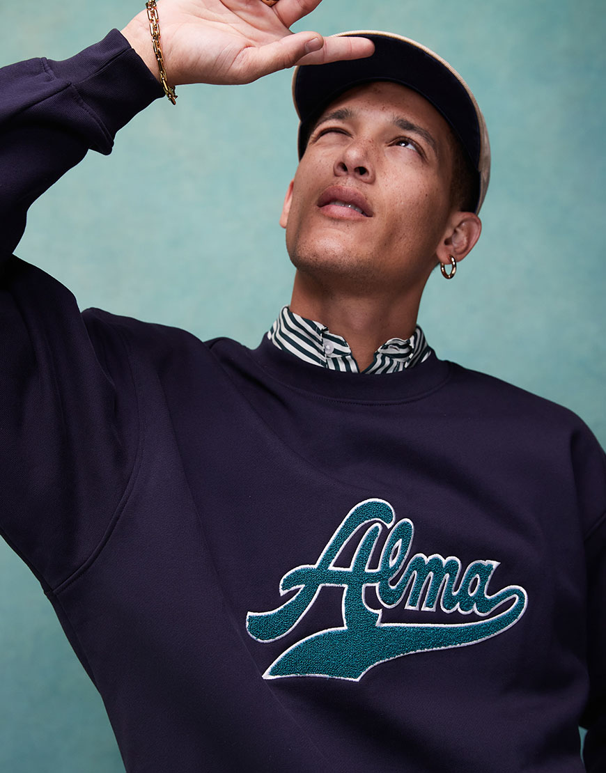 Model wearing Alma de Ace sweatshirt and striped shirt | ASOS Style Feed