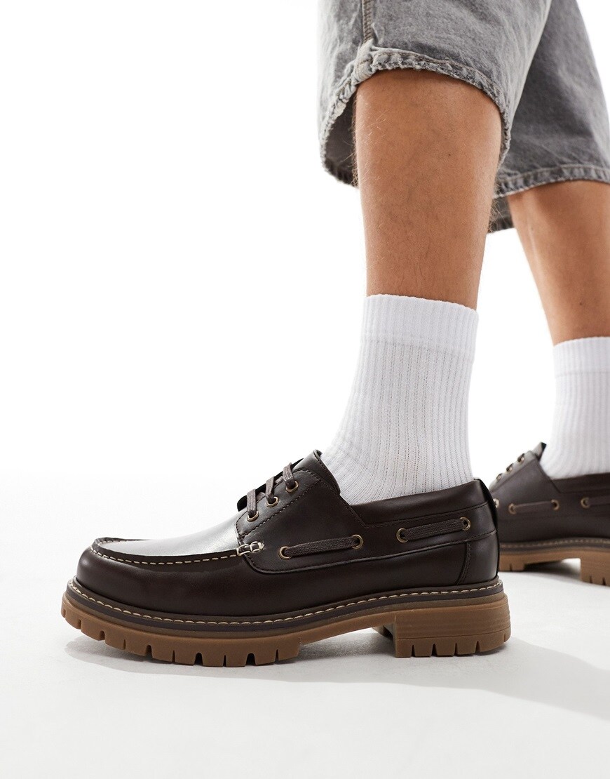 Model wearing dark brown boat shoes