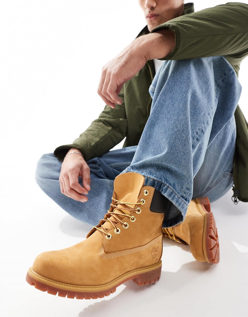 Model wearing tan Timberland boots with blue jeans