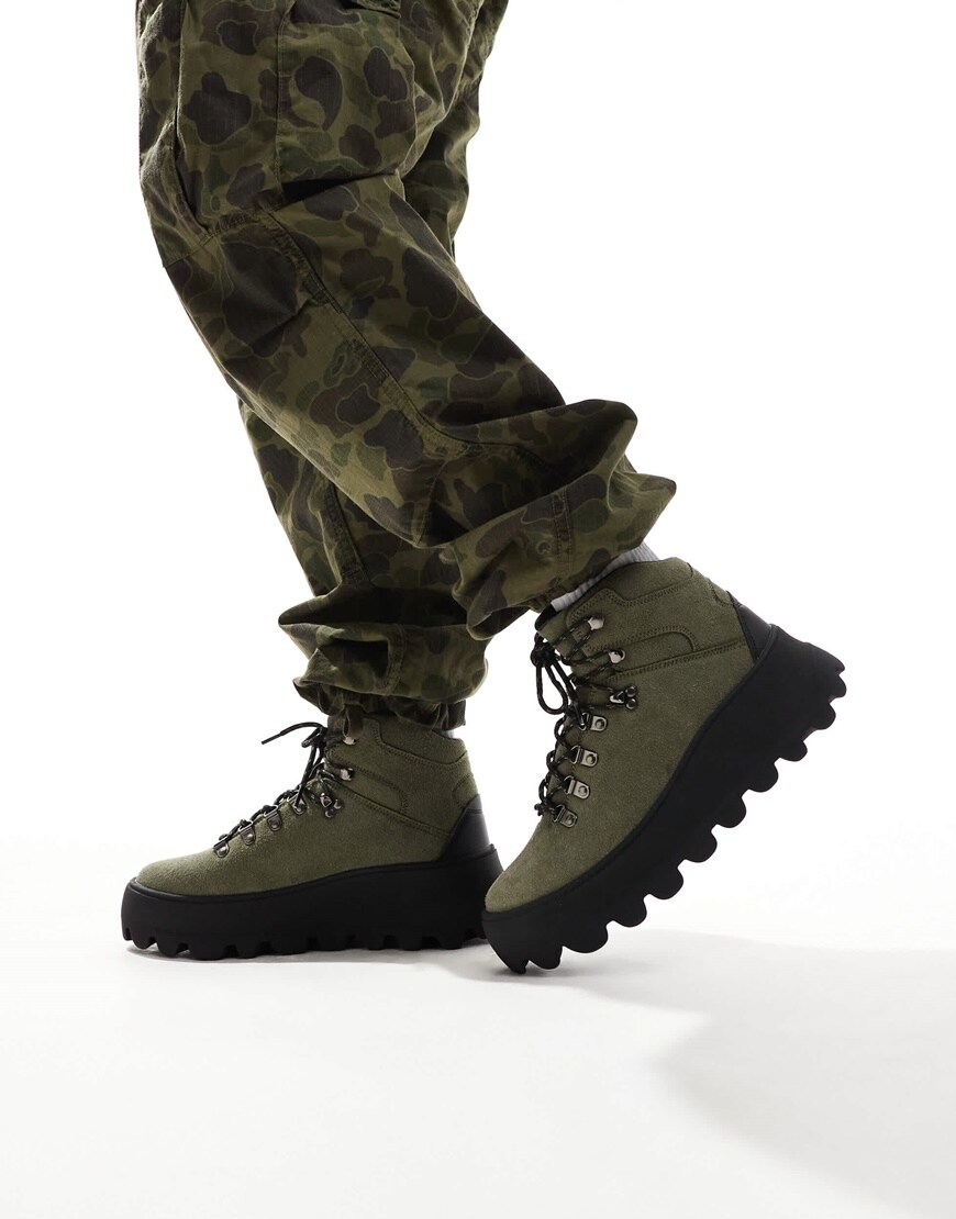 Army green hiking boots worn with camo trousers