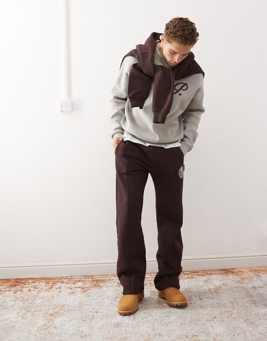 Model wearing grey sweatshirt and brown joggers