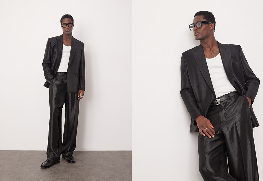 Model wearing black shiny suit