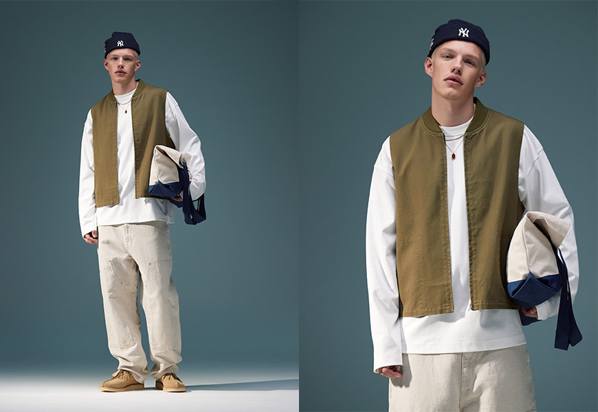 Model wearing beige trousers, a white t shirt and a beanie