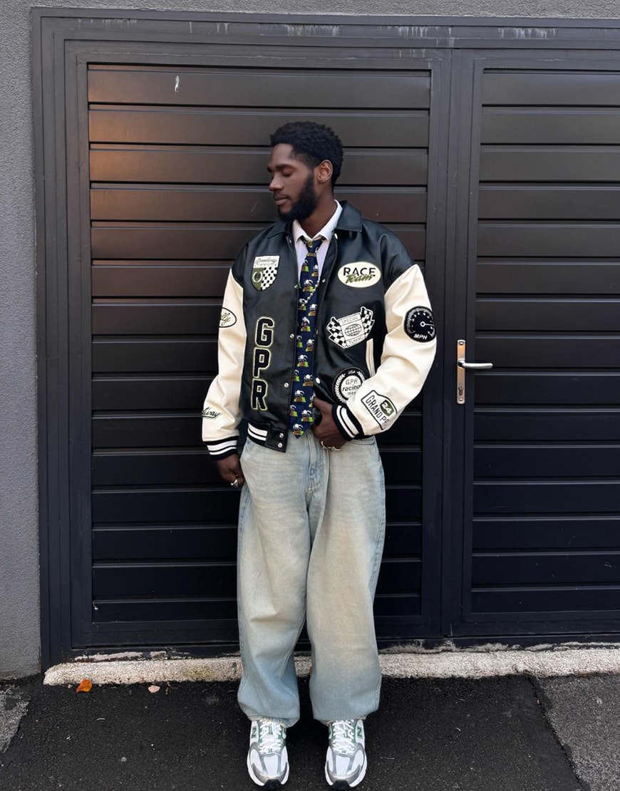 Model wearing a streetwear outfit in front of a black background