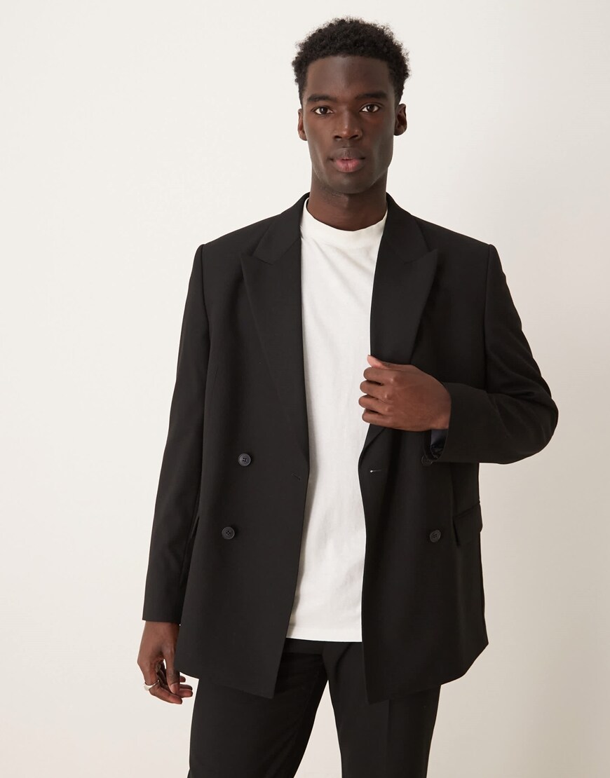 Model wearing boxy black suit jacket
