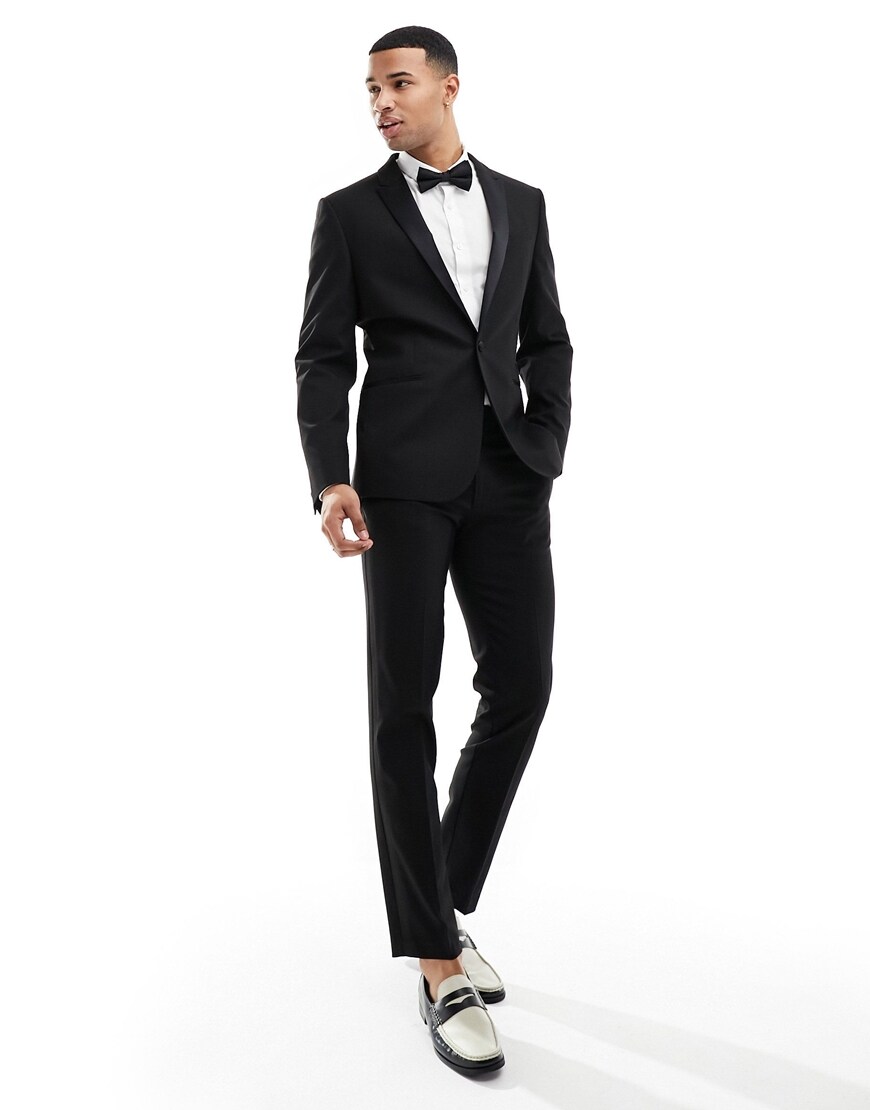 Model wearing black tuxedo