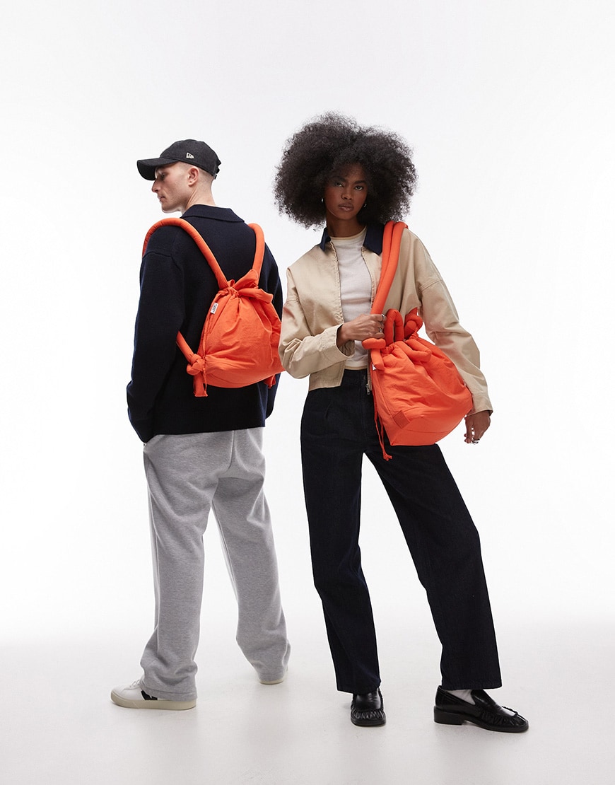 Two models wearing an orange Ölend bag two different ways | ASOS Style Feed