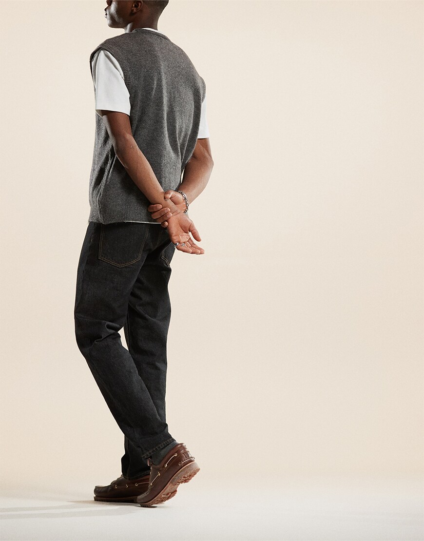 Man wearing black straight jeans