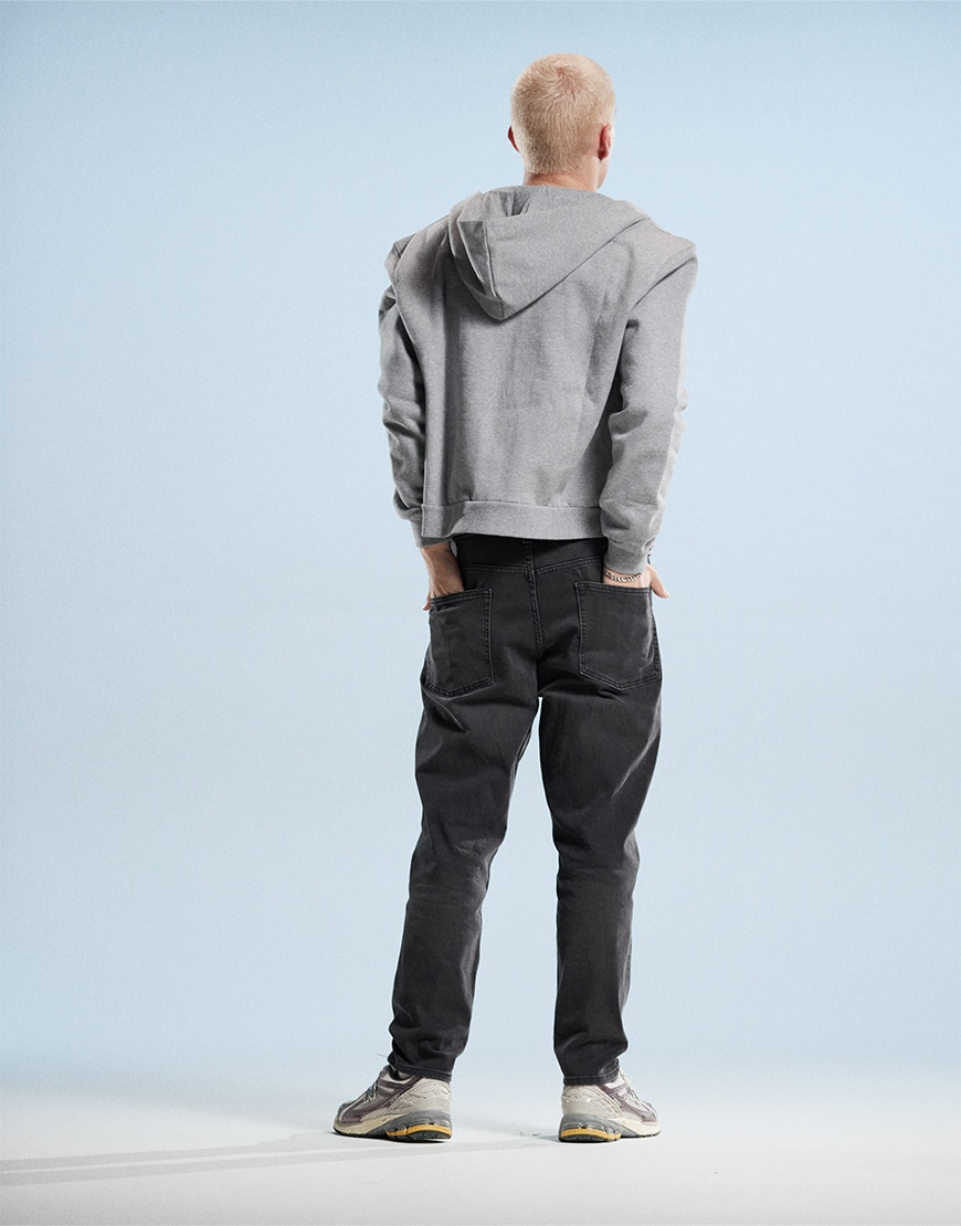 Man wearing black tapered jeans