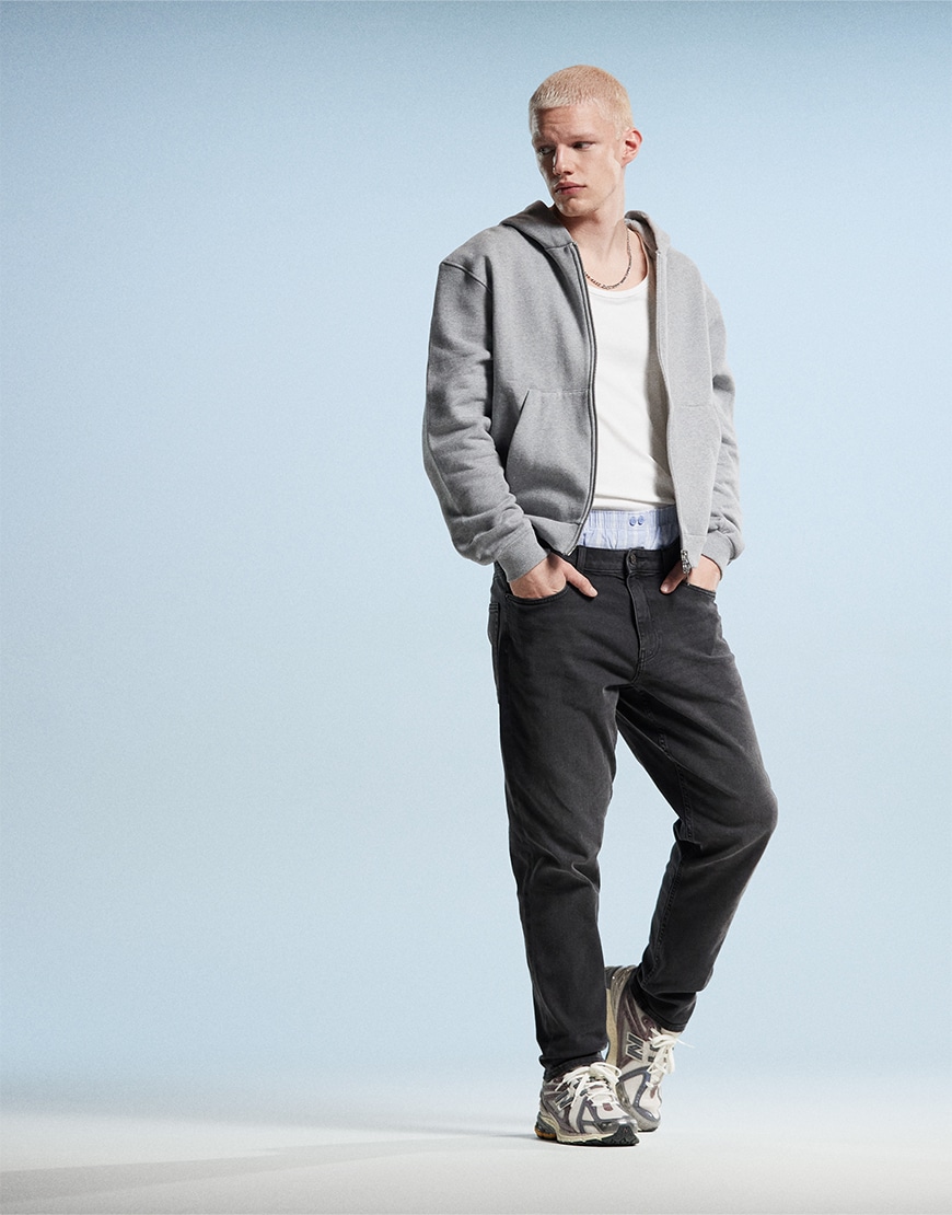 Man wearing black tapered jeans