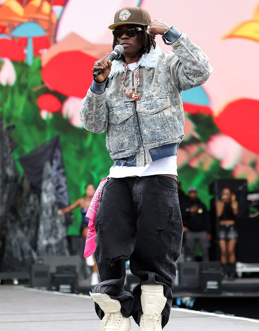 Rema wearing a denim jacket and jeans