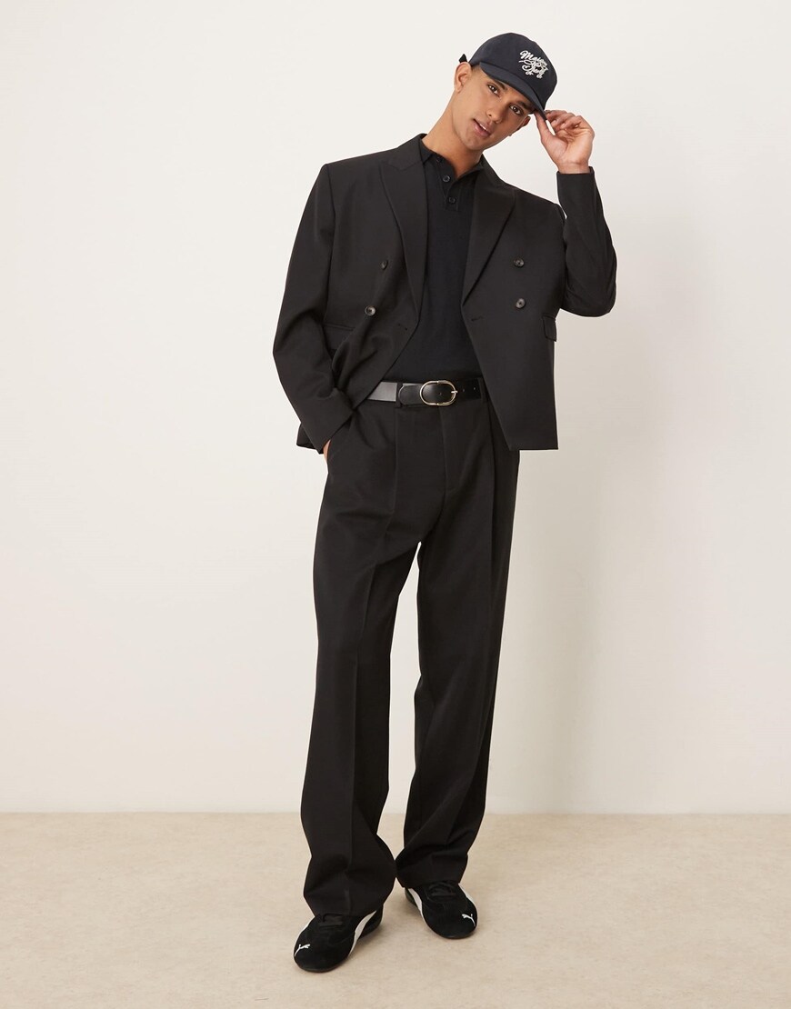 Model wearing black trousers