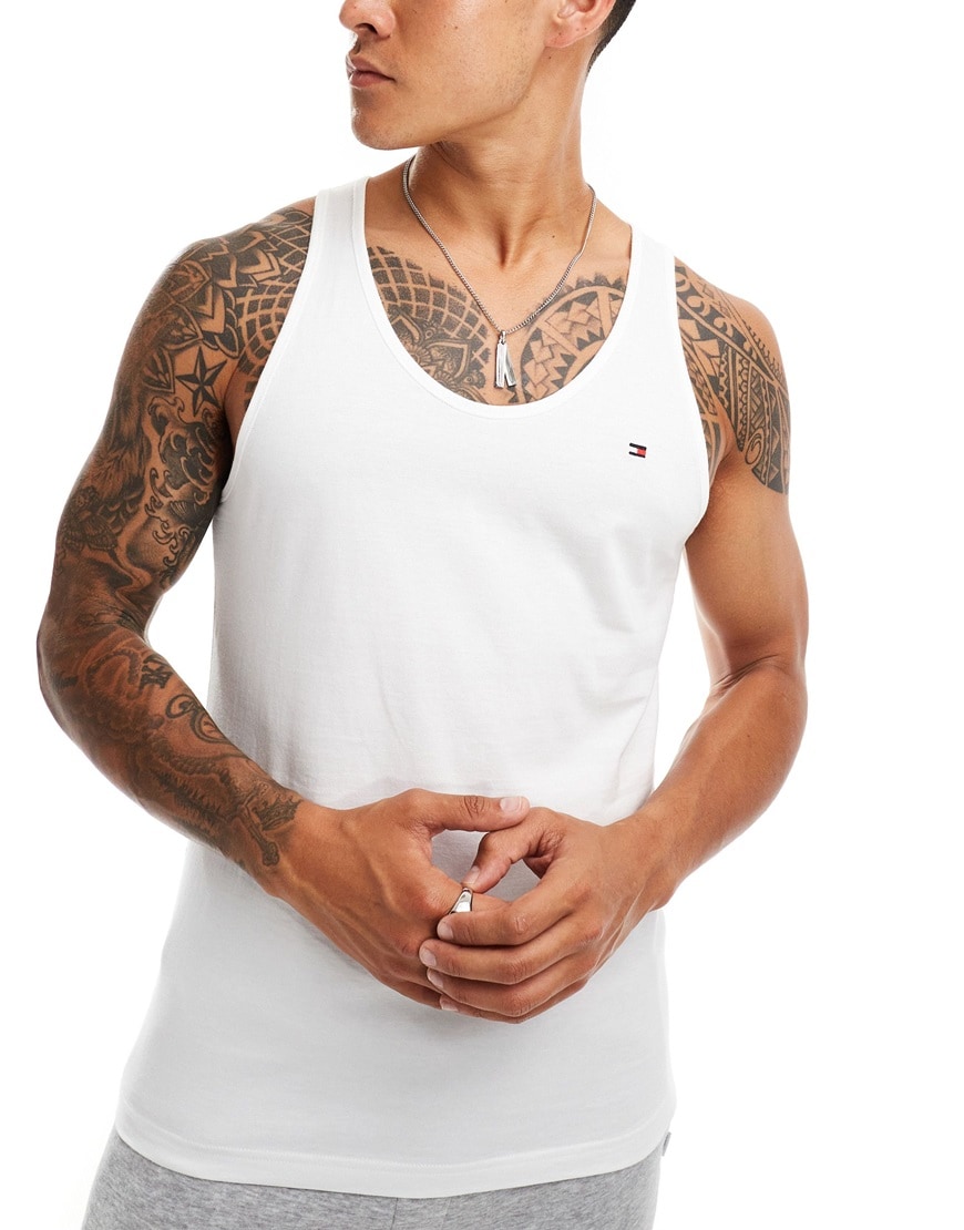 Model wearing a white tank top