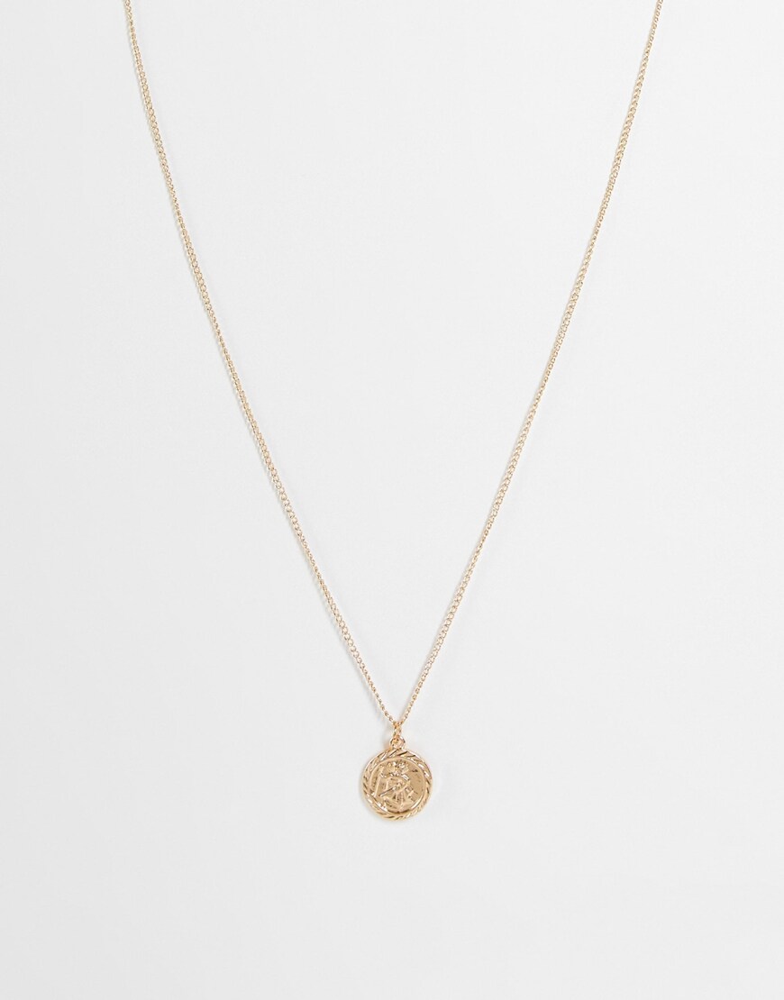 A model wearing a gold-tone necklace