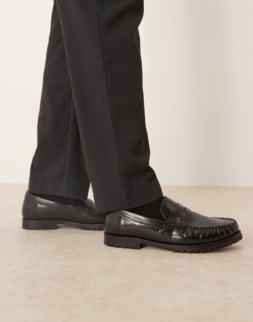 A model wearing black loafers