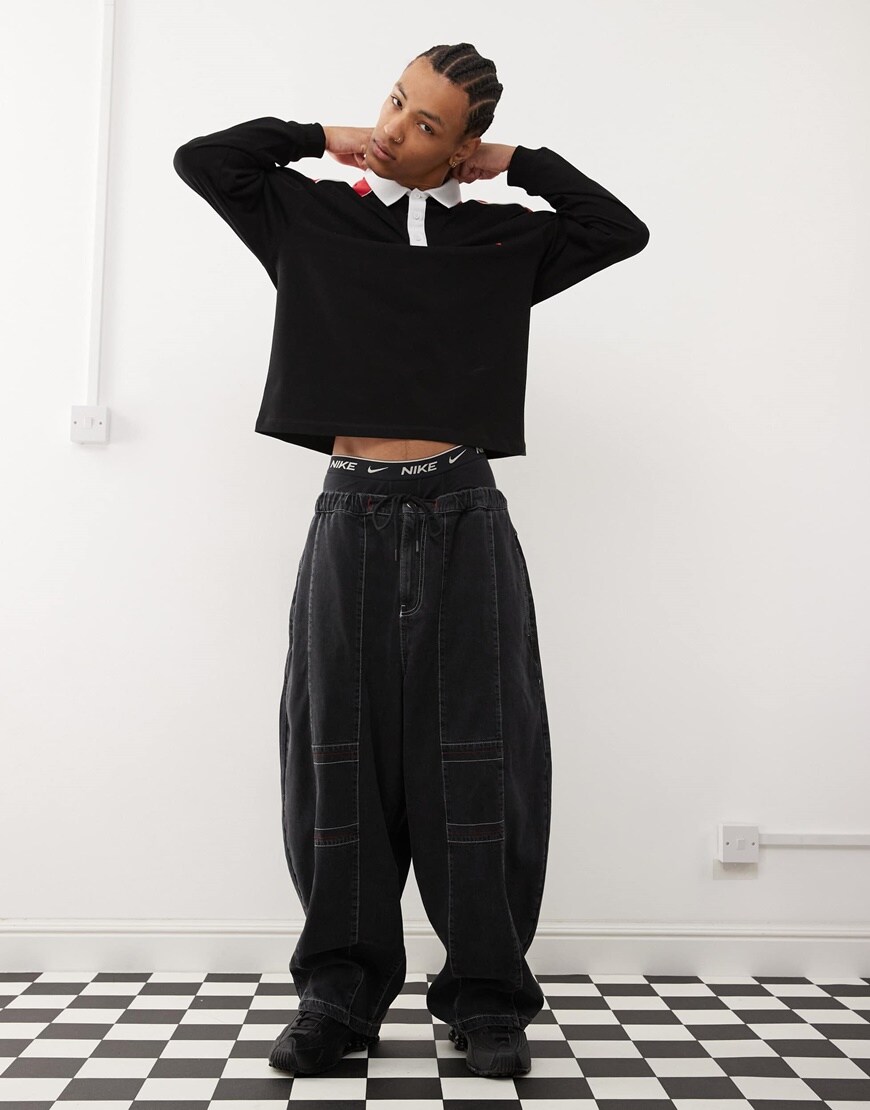 A model wearing a black rugby top